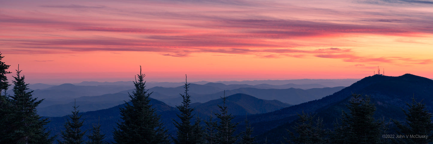 A glorious pink and orange sunset glows above the misty blue Smoky Mountains. Fine Art photography image by McClusky Nature Photography.