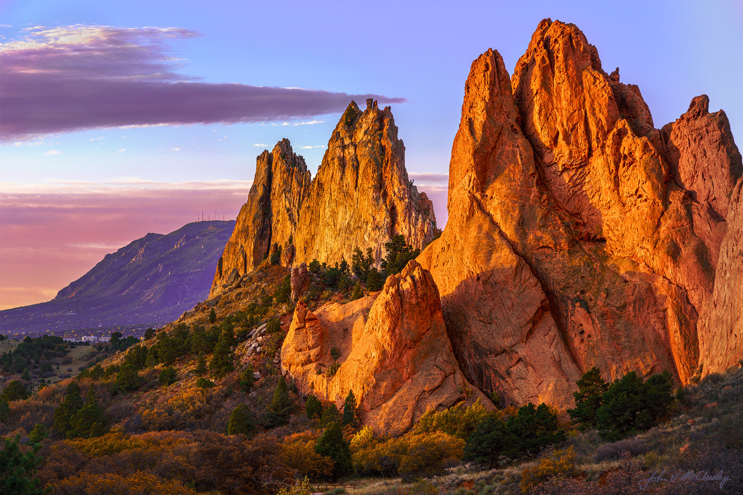 The sandstone cliffs at the Garden of the Gods Colorado glow in the orange light of the rising sun.  Fine art landscape photo by McClusky Nature Photography.