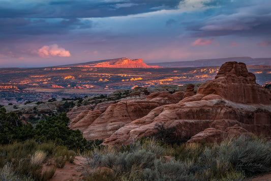 Sunset over a Canyonlands desert landscape with red rock formations
