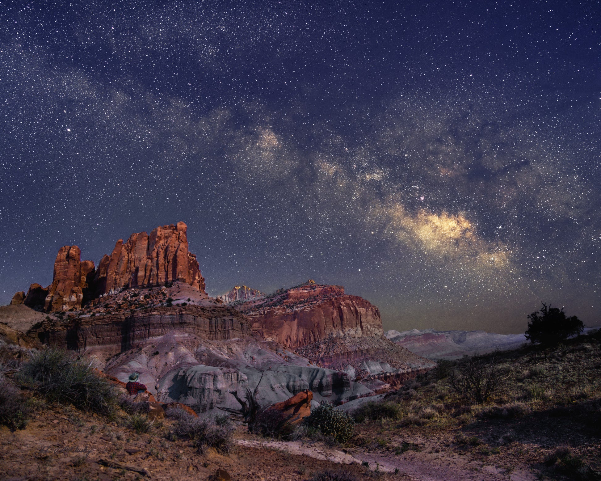 The moon lights the cliffs of Capitol Reef National Park while the Milky Way glows in the night sky in this landscape photography print from the Chimney Rock Trail.