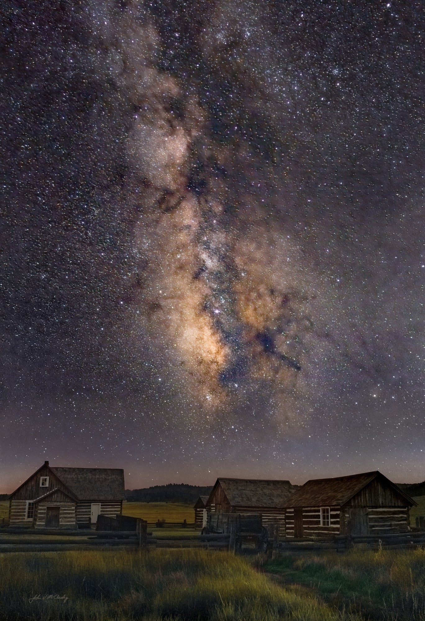 The stars light the Hornbeck Homestead while the Milky Way glows in the night sky in this landscape photography print from the Florissant Fossil Bed National Monument.