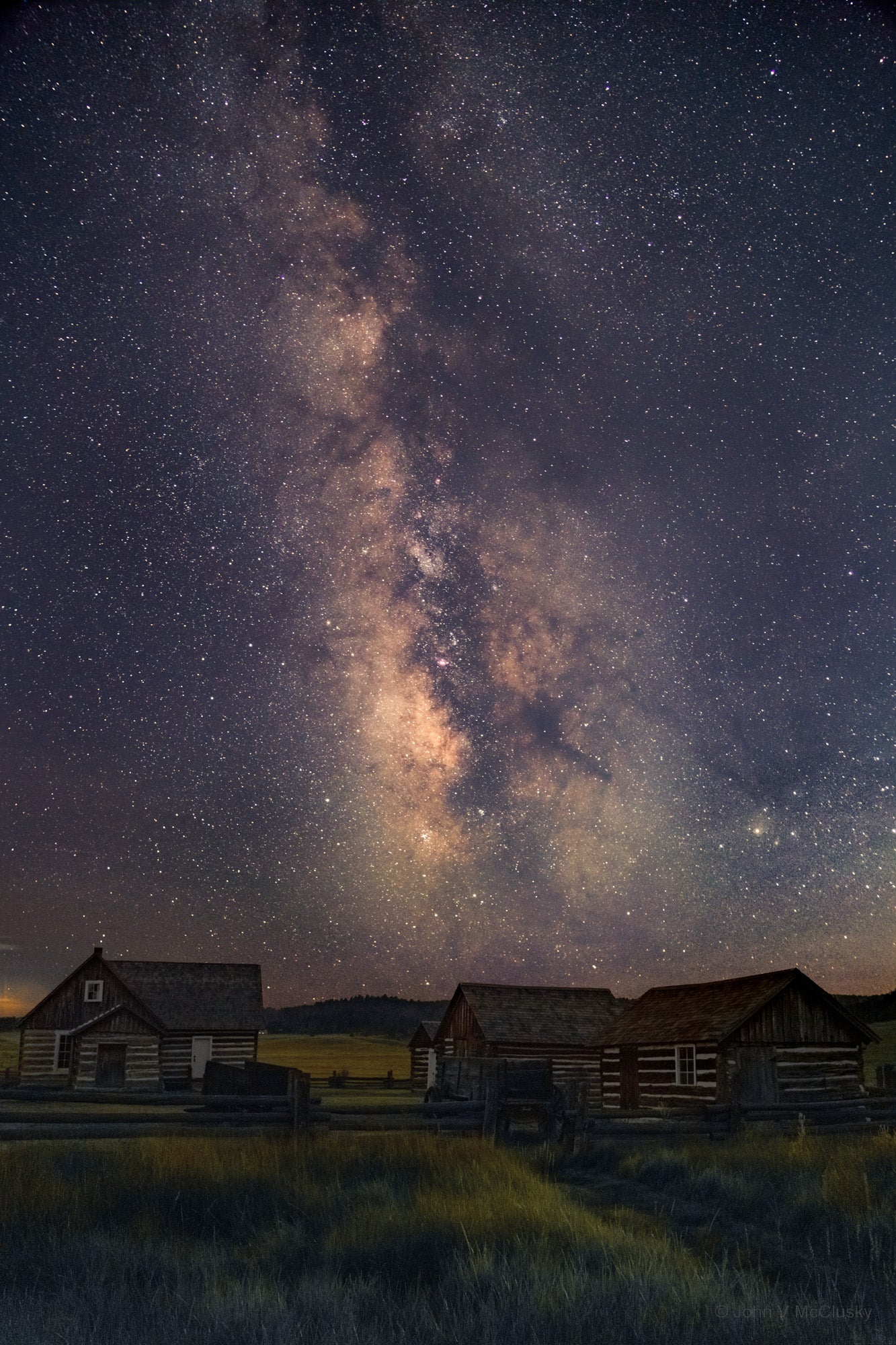 The stars light the Hornbeck Homestead while the Milky Way glows in the night sky in this landscape photography print from the Florissant Fossil Bed National Monument.