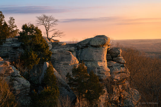 The last light of sunset reflects off the sandstone cliffs of Garden of the Gods, Illinois.  The pastel sky and gently lit rolling woodlands grace the horizon in this landscape photography print by McClusky Nature Photography.